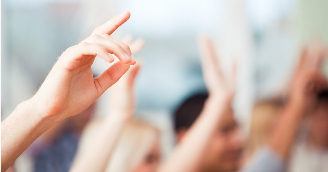 hands raised in the classroom