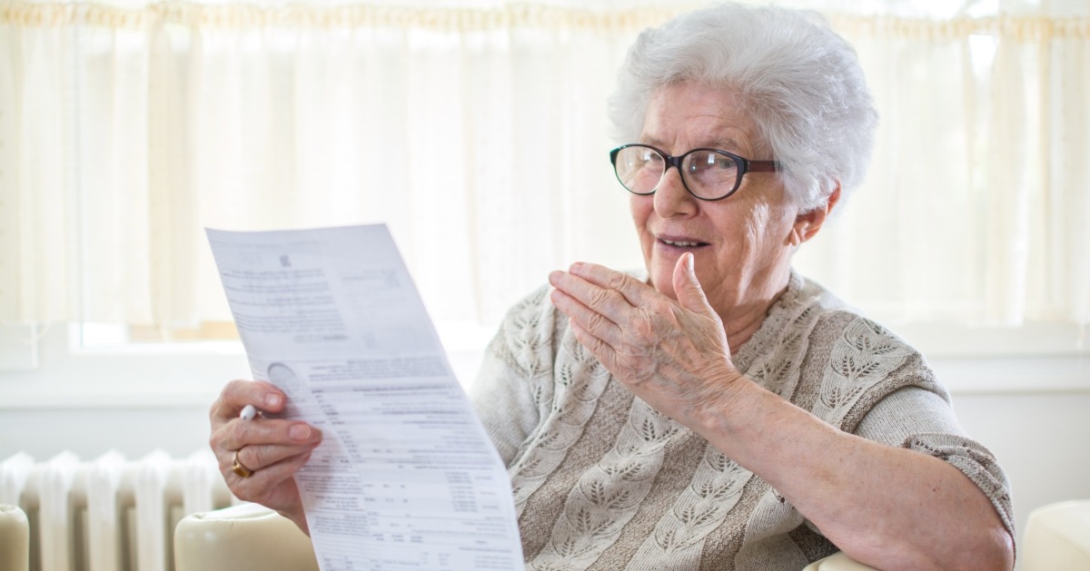 senior citizen looking at bills