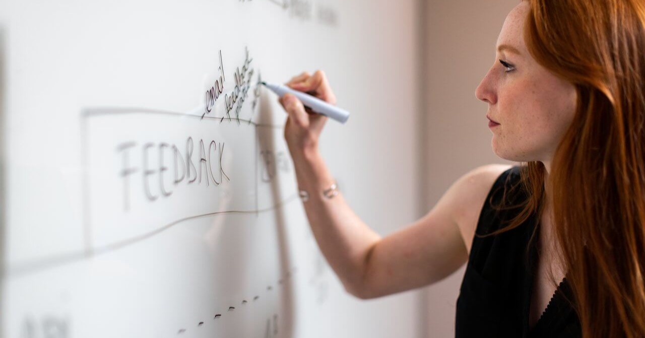 Teacher writing on whiteboard